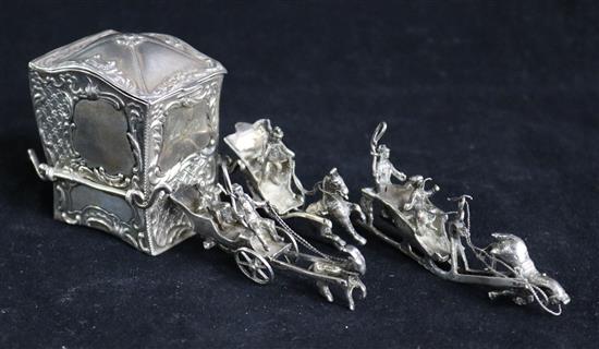 A late Victorian silver box modelled as a carriage (incomplete) by Goldsmiths & Silversmiths and 3 small silver figural groups